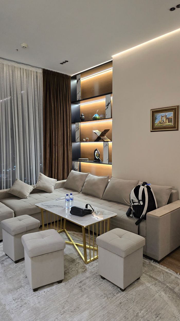 A stylish modern living room with cozy seating and elegant decor, perfect for relaxation.